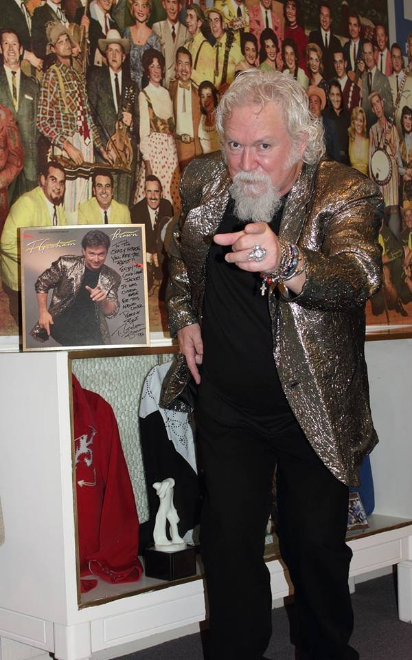 country legend t graham brown trying on his old stage suit at the museum